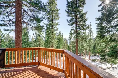 a wooden deck with trees in the background at 6 Mi to Ski Slopes! Family Tahoe Cabin with 3 Decks in Tahoe Vista