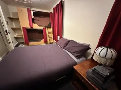 a small bedroom with a bed and a mirror at West River House in Truckee