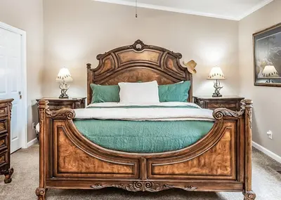 a large wooden bed in a bedroom with two lamps at Eagle Retreat Mountain Escape New With AC in Shaver Lake