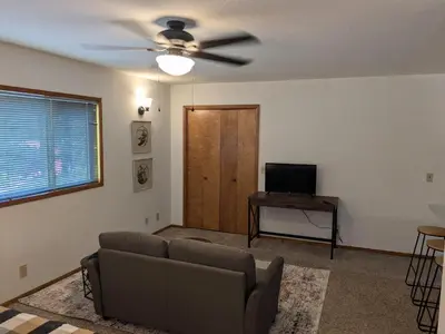 a living room with a couch and a ceiling fan at Bulldog Den in Twain Harte