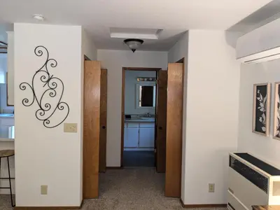 a hallway with a door leading to a kitchen at Bulldog Den in Twain Harte