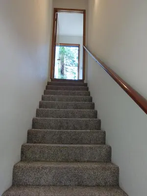 a staircase in a house with a door and a window at Bulldog Den in Twain Harte
