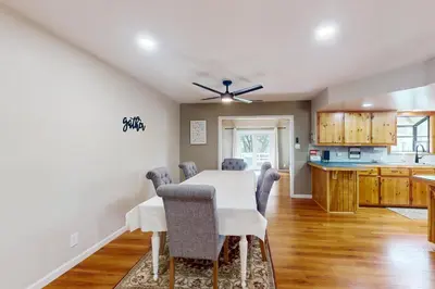 a dining room and kitchen with a white table and chairs at Uhre Family Retreat in Oakhurst