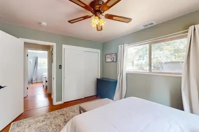 a bedroom with a bed and a ceiling fan at Uhre Family Retreat in Oakhurst