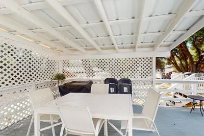 a white table and chairs on a patio at Uhre Family Retreat in Oakhurst