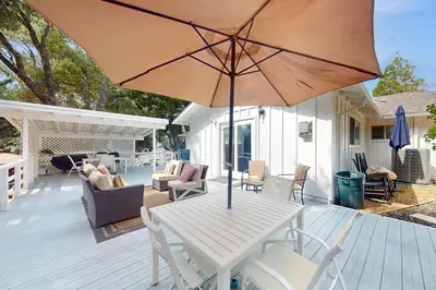 a white table with an umbrella on a deck at Uhre Family Retreat in Oakhurst