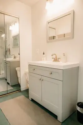 a white bathroom with a sink and a mirror at Romantic Yosemite Retreat - Private Zen Hot Tub in Mariposa