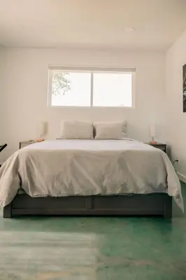 a white bedroom with a large bed with a window at Romantic Yosemite Retreat - Private Zen Hot Tub in Mariposa