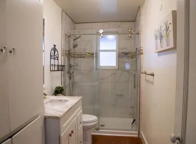 a bathroom with a shower and a toilet and a sink at Yosomite Gateway Historic Victorian with Modern Touch in Sonora