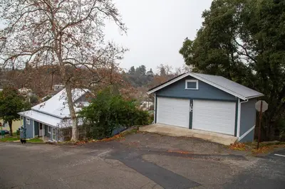 a house with a garage on the side of a street at Yosomite Gateway Historic Victorian with Modern Touch in Sonora