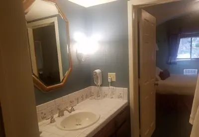 a bathroom with a sink and a mirror at GetAways at Olympic Village Inn in Olympic Valley