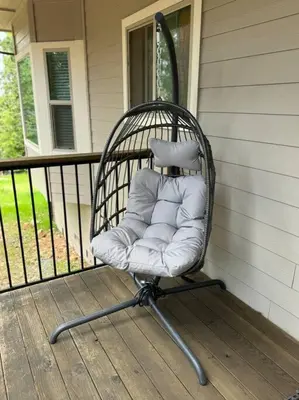 a wicker chair sitting on the porch of a house at Family get away Near Sly Park Lake & Apple Hill in Pollock Pines