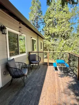 a deck with chairs and a table on a house at Family get away Near Sly Park Lake & Apple Hill in Pollock Pines