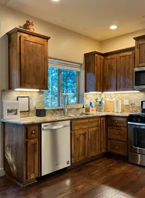 a kitchen with wooden cabinets and a sink at Family get away Near Sly Park Lake & Apple Hill in Pollock Pines
