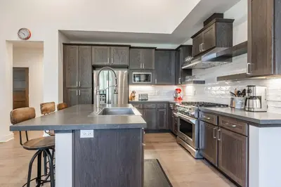 a kitchen with wooden cabinets and stainless steel appliances at Newly Built Townhome in Snowcreek Creekhouse #1324 Three Bed Three Baths Sleeps 8! Mountain Views! in Mammoth Lakes