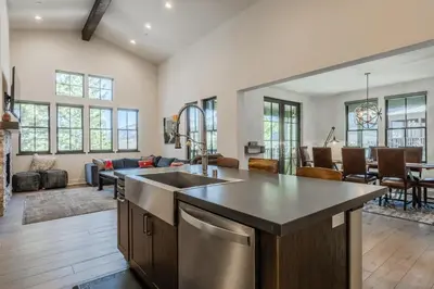 an open kitchen and living room with a table at Newly Built Townhome in Snowcreek Creekhouse #1324 Three Bed Three Baths Sleeps 8! Mountain Views! in Mammoth Lakes