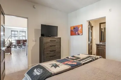 a bedroom with a bed and a flat screen tv at Newly Built Townhome in Snowcreek Creekhouse #1324 Three Bed Three Baths Sleeps 8! Mountain Views! in Mammoth Lakes