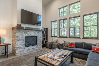 a living room with a fireplace and a tv at Newly Built Townhome in Snowcreek Creekhouse #1324 Three Bed Three Baths Sleeps 8! Mountain Views! in Mammoth Lakes