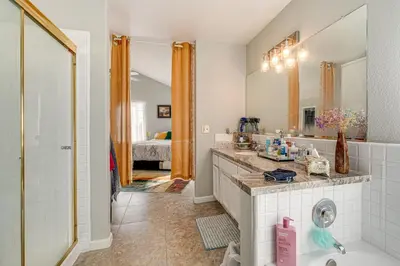 a bathroom with a sink and a mirror at Water Views and Decks Spacious La Grange Retreat in La Grange