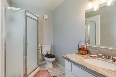 a bathroom with a shower and a toilet and a sink at Water Views and Decks Spacious La Grange Retreat in La Grange