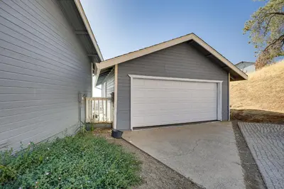 a garage with a white garage door next to a house at Water Views and Decks Spacious La Grange Retreat in La Grange