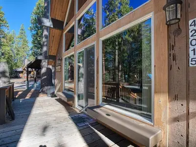 a house with large windows on the side of it at Elderberry Bluejay Location Goals Tub Time in Shaver Lake