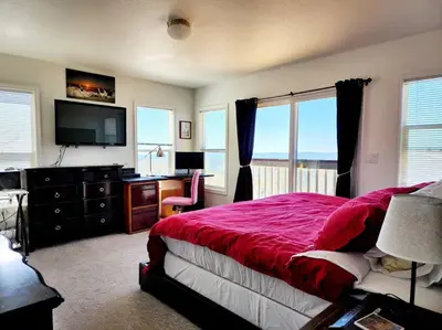 a bedroom with a bed and a desk and a television at Majestic View in Mariposa