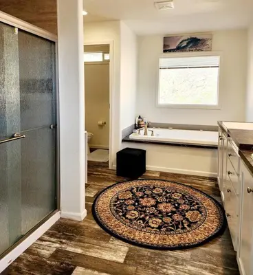 a bathroom with a tub and a rug on the floor at Majestic View in Mariposa