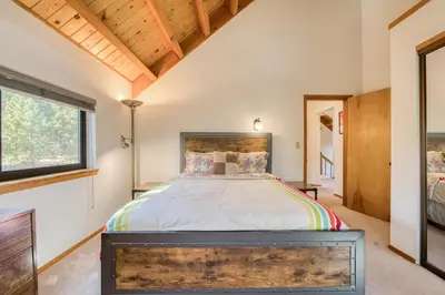 a bedroom with a bed and a window at Dwell by Tahoe Getaways - 3BR Tahoe Donner w Sauna & HOA Amenities in Truckee