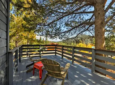 a deck with two chairs and a table and a tree at Dwell by Tahoe Getaways - 3BR Tahoe Donner w Sauna & HOA Amenities in Truckee
