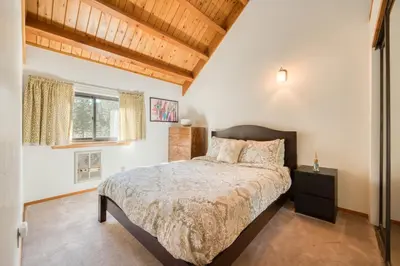 a bedroom with a bed and a wooden ceiling at Dwell by Tahoe Getaways - 3BR Tahoe Donner w Sauna & HOA Amenities in Truckee