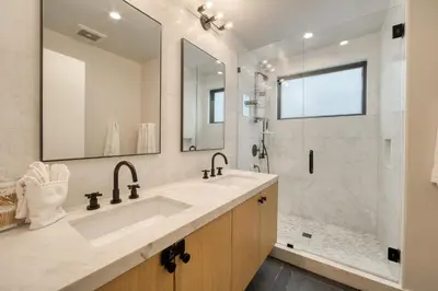 a white bathroom with a sink and a shower at Lightning Run at Palisades - 3 BR 3 BA Condo steps to Palisades Tahoe- Ski Shuttle in Olympic Valley