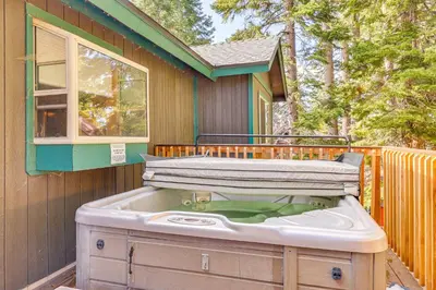 a hot tub sitting on the side of a house at 7 Mi to Beach Home with Hot Tub in South Lake Tahoe in South Lake Tahoe