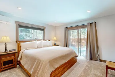 a bedroom with a large bed and a window at Nature Lovers' Retreat in South Lake Tahoe
