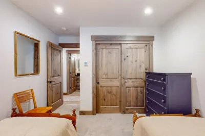 a bedroom with two beds and a blue dresser at Nature Lovers' Retreat in South Lake Tahoe