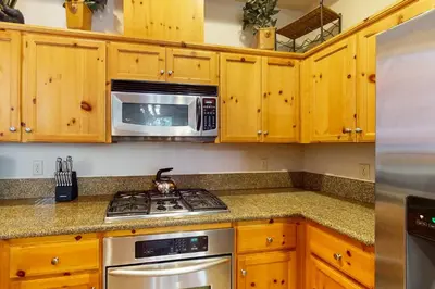 a kitchen with a stove and a microwave at Baby Bear Bliss in Shaver Lake