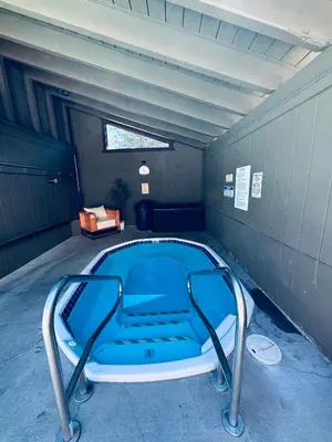 a swimming pool in a room with a blue tub at Cozy Condo in Mammoth with 2 parking spots! Ski,Snowboard, Ice skate! in Mammoth Lakes