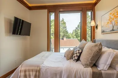 a bedroom with a bed with a large window at Obsidian 170 in Mammoth Lakes