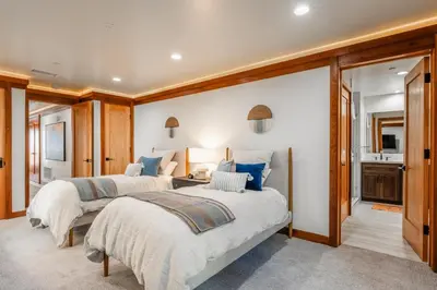 two beds in a large room with a kitchen at Obsidian 170 in Mammoth Lakes