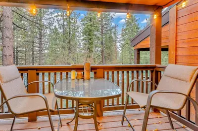 a glass table and chairs on a wooden deck at Tahoe Condo Near Skylandia Beach in Tahoe City
