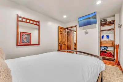 a bedroom with a white bed and a closet at Tahoe Condo Near Skylandia Beach in Tahoe City