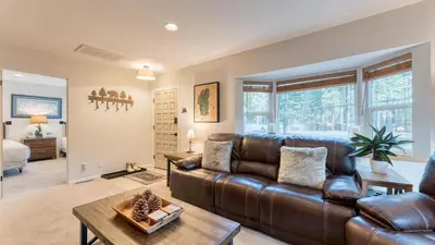 a living room with a leather couch and a table at Westlake Cabin by AvantStay Hot Tub Near Skiing Walk to Restaurants Lake in Tahoe City