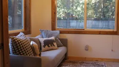 a couch with pillows on it in a room with windows at Westlake Cabin by AvantStay Hot Tub Near Skiing Walk to Restaurants Lake in Tahoe City