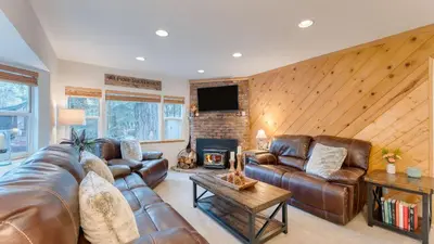 a living room with a leather couch and a fireplace at Westlake Cabin by AvantStay Hot Tub Near Skiing Walk to Restaurants Lake in Tahoe City