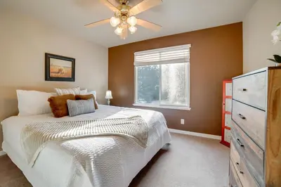 a bedroom with a white bed and a window at Ski Getaway with Hot Tub Reno Home By Attractions in Reno