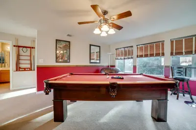 a pool table in a room with a ceiling fan at Ski Getaway with Hot Tub Reno Home By Attractions in Reno