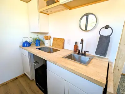 a kitchen with a sink and a counter top at Wildhaven Yosemite Glamping in Mariposa