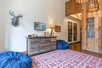a living room with a blue couch and a dresser at Northstar Escape in Kingswood Estates