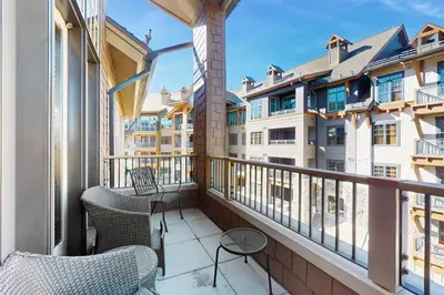 a balcony with chairs and a view of buildings at Northstar Getaway in Truckee