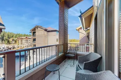 a balcony with chairs and a view of the water at Northstar Getaway in Truckee